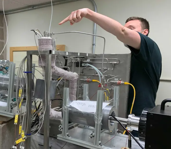 Former student Cody Falconer points to key component of molten salt loop