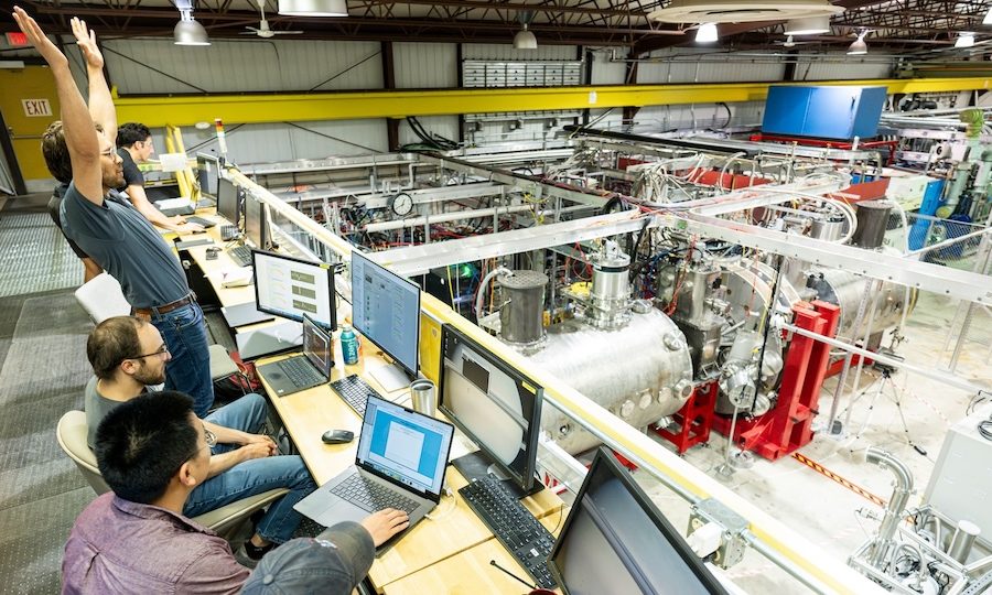 Researchers celebrate achieving a plasma from the control room at the Wisconsin HTS Axisymmetric Mirror Project (WHAM) experiment